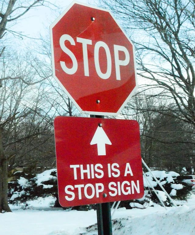 A photo of a red, 8-sided road stop sign with another small sign below noting that the original sign is a stop sign.